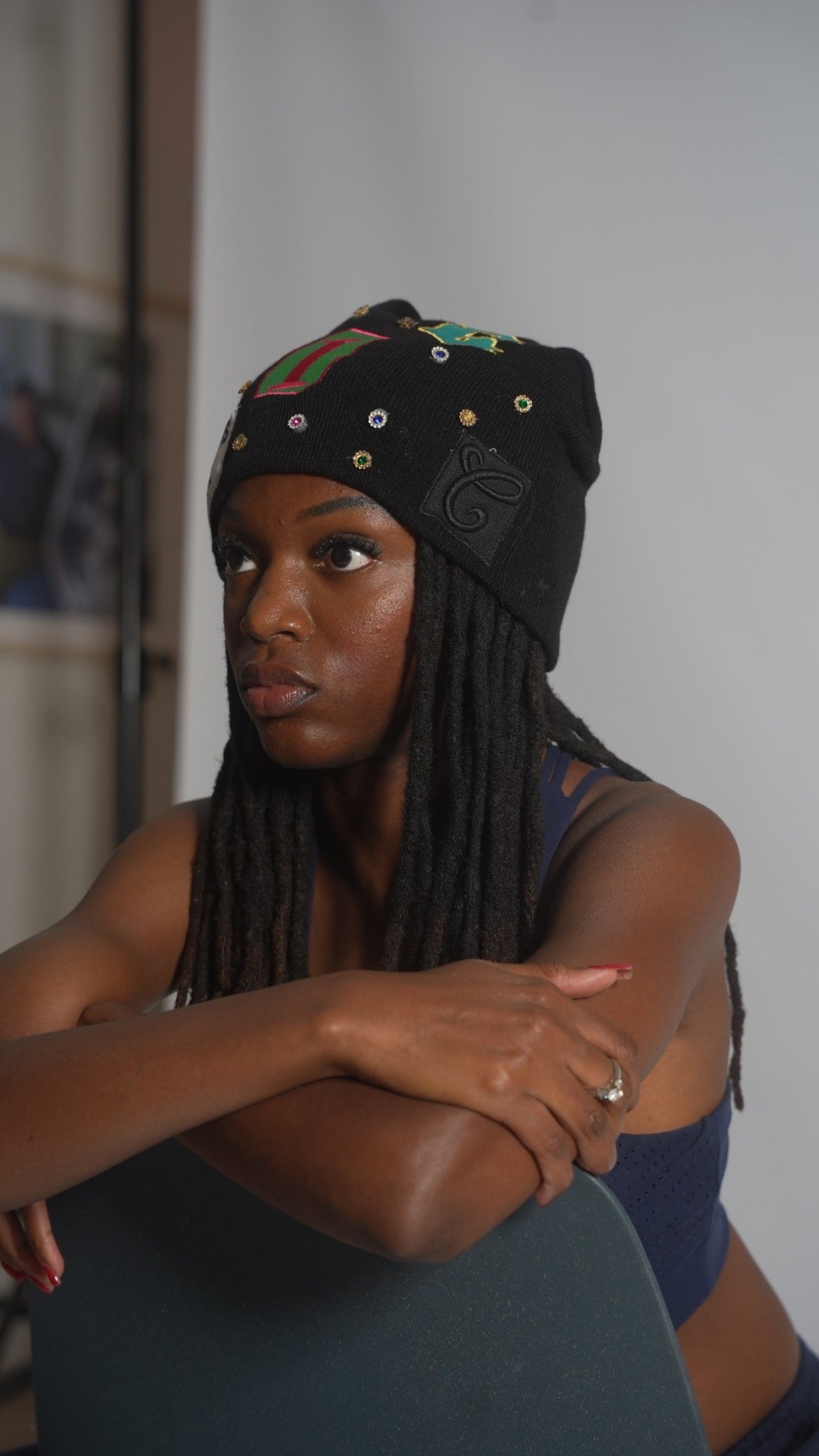 CIC gemstone beanie in black, showing the C crest patch and gemstones