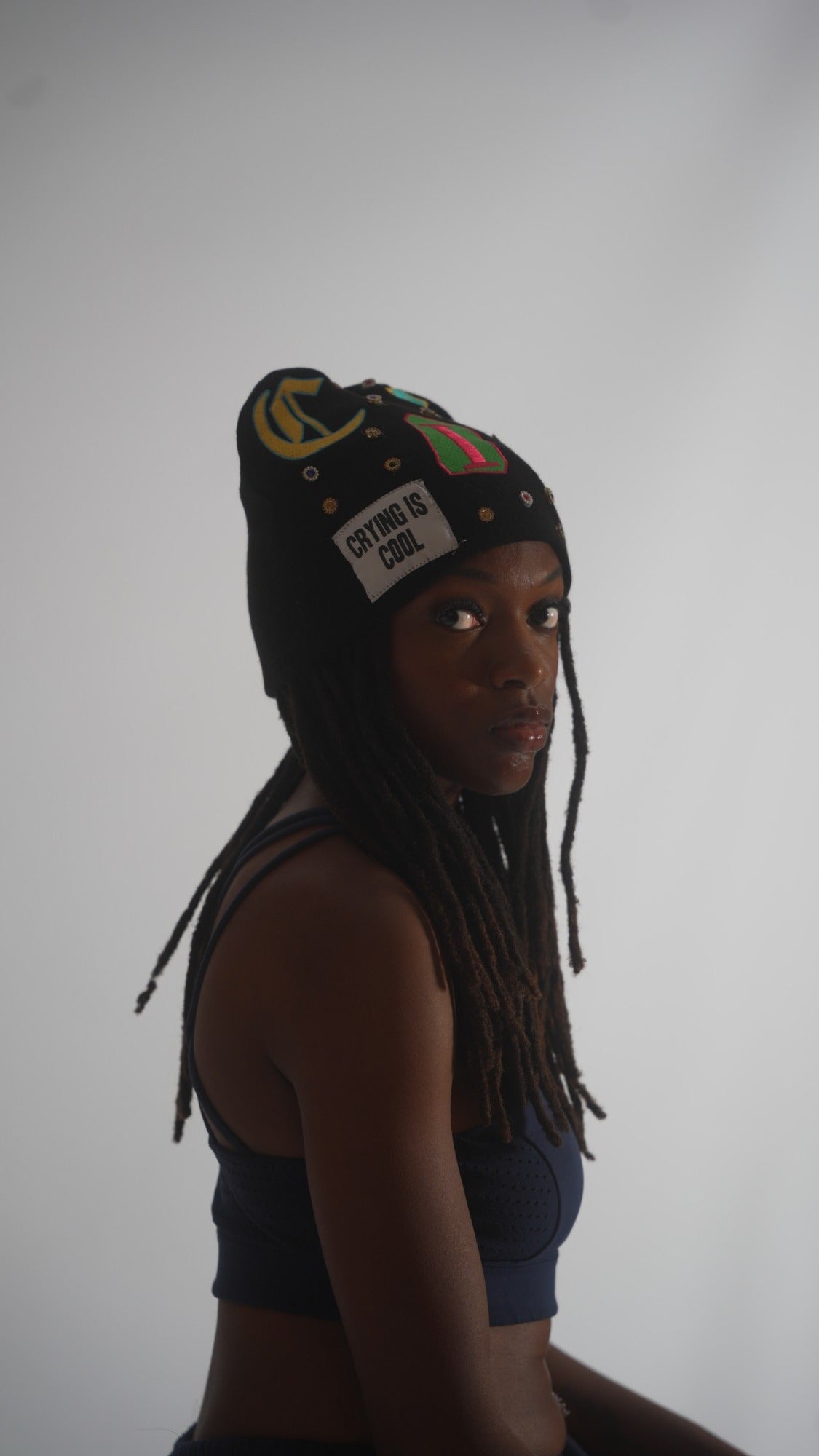 CIC gemstone beanie in black, side view with the Crying Is Cool patch