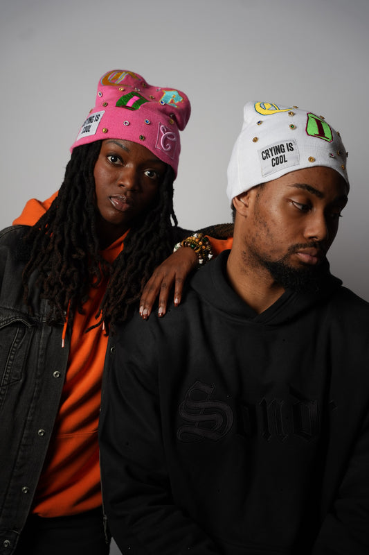 CIC gemstone beanies in pink and white, worn by two models