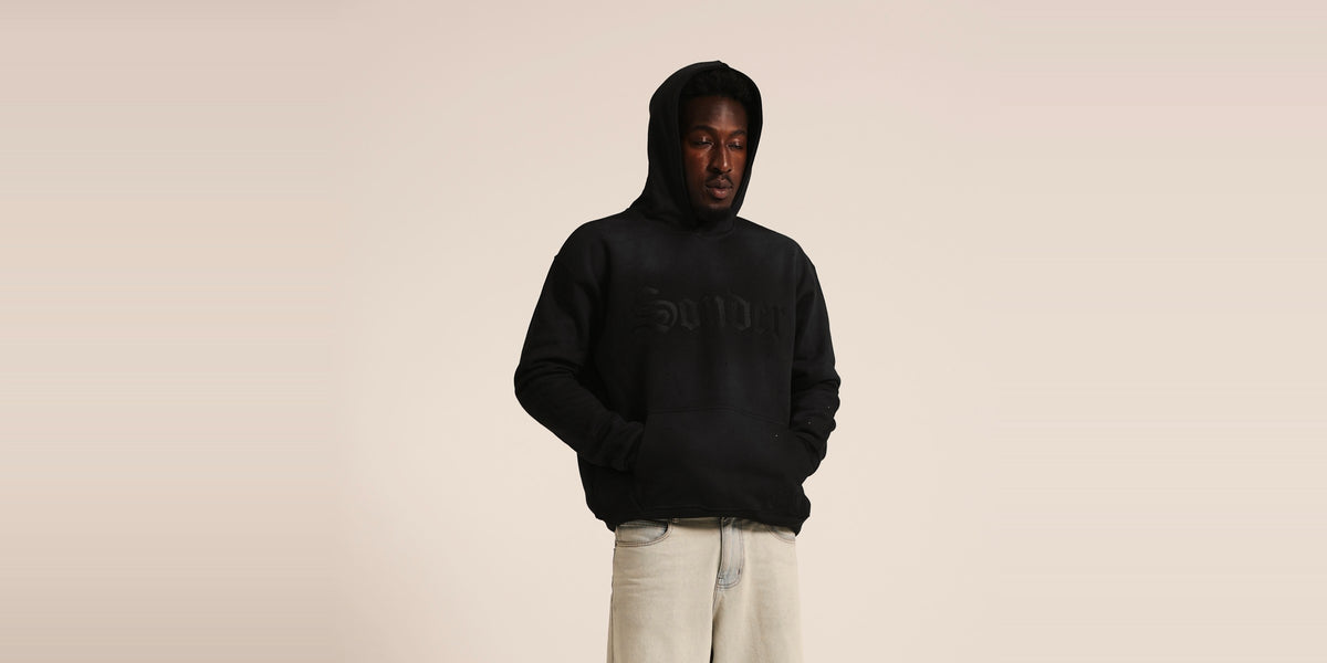 Sonder hoodie, hood up looking down, studio, wide banner
