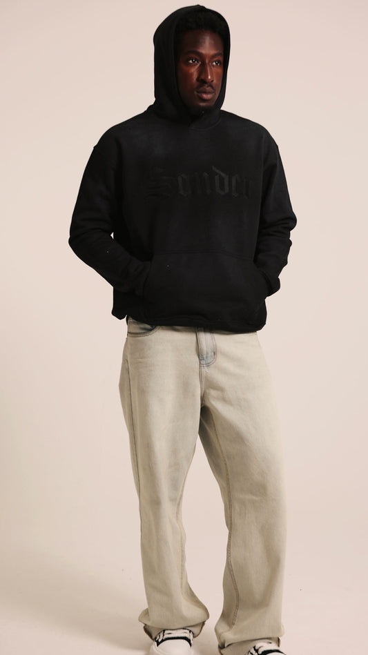 Sonder Rhinestone Hoodie in Washed Black, hands in pocket